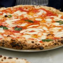 una pizza appoggiata su un piatto su un tavolo