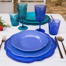 a table with blue plates and glasses on a table