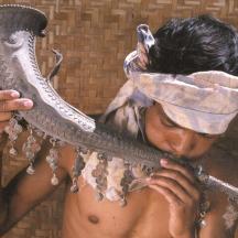 a woman with a mask on her head holding a mirror