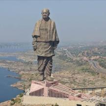 a statue of a man standing on top of a building