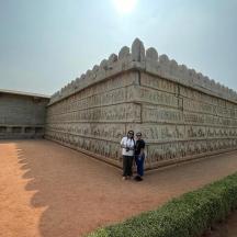 two people standing in front of a building