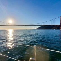a boat in the water in front of a bridge