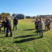 a group of people standing around in a field