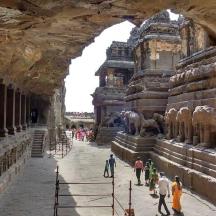 a group of people walking around an ancient building