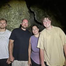a group of men standing in a cave