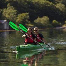 two people are in a kayak on a lake