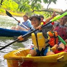 a group of people in a kayak on a river