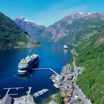 a cruise ship is docked in a mountain lake