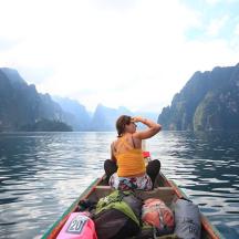 a woman sitting in a boat on the water