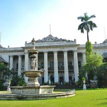 a large building with a fountain in front of it