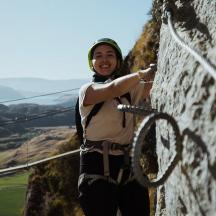 a woman standing on top of a mountain