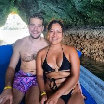 a man and a woman in a boat in a cave
