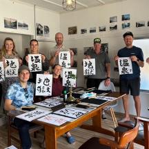 a group of people holding up signs with kanji