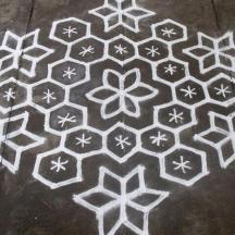 a rangoli design on a concrete floor