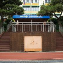 a set of stairs with a white door and a building