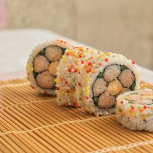 three sushi rolls sitting on top of a table