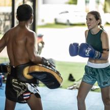 a boy and a girl with boxing gloves in a gym