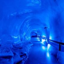 a blue tunnel with ice sculptures in it