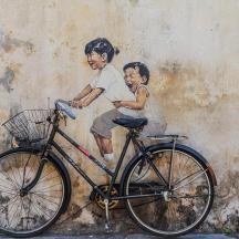 a painting of a boy and a child on a wall
