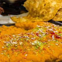 a pizza sitting on top of a table with toppings