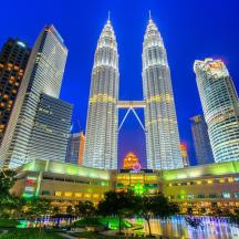 a group of tall skyscrapers in a city at night