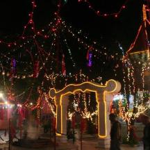 a display of christmas lights and a gate at night