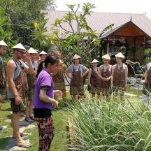 a group of people wearing hats standing in a garden