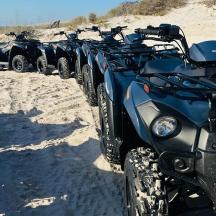 a row of atvs parked in the sand