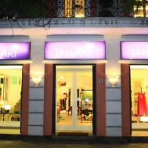 a store front with purple neon signs in front