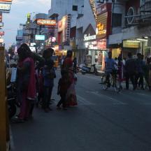 a group of people standing on a busy city street