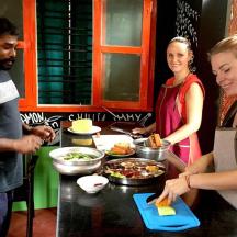 a group of people preparing food in a kitchen
