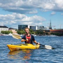 a man in a yellow kayak in the water