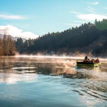 a group of people in a boat on a river