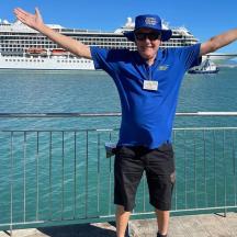 a man standing in front of a cruise ship