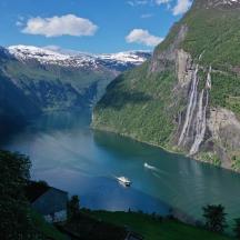 a boat in the middle of a lake with mountains