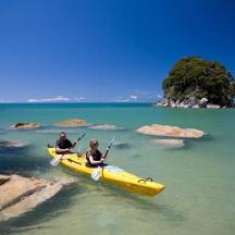 two people in a yellow kayak in the water