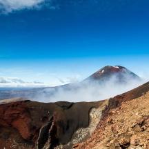people standing on top of a mountain in the clouds