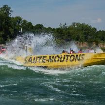 a yellow boat in the water on a river