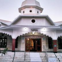 a large white building with a clock tower