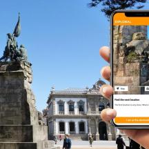 a person taking a picture of a statue in front of a building