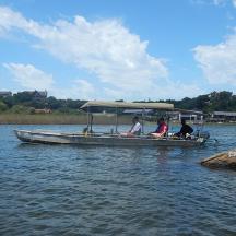 a group of people sitting on a boat on the water
