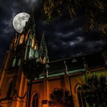 a church with a full moon on top of it
