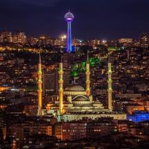 a view of a city at night with a tower