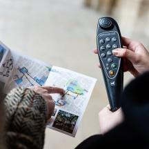 a person holding a remote control in their hand