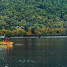 a small boat in the middle of a lake