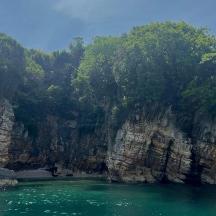 a view of a river with a rocky cliff
