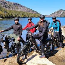 a group of people sitting on their bikes by the water