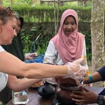a woman is making a pot on a table