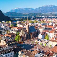 an aerial view of a city with buildings and mountains