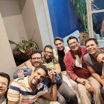 a group of men sitting on a couch posing for a picture